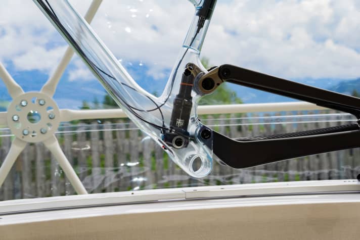   The lower shock mount is located in the bottom bracket area of the main frame. The movement is transferred from the seat stays to the inside of the frame via a lever on the upper shock mount.