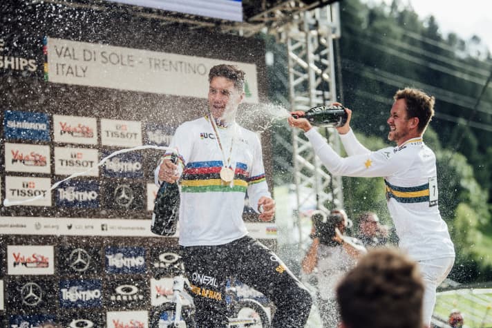   Greg Minnaar celebrates with Troy Brosnan (right). The Australian took bronze after a strong run.