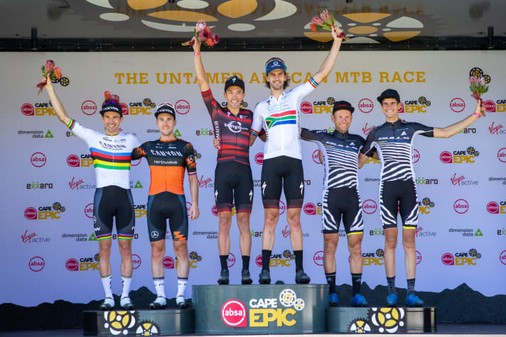   The men's podium on the second stage: Jordan Sarrou and Matt Beers at the top, Canyon Northwave on the left and the Bulls team with Urs Huber and Simon Schneller in third place.