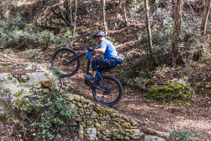 The front wheel touches down on the step, the good foot and the right pedal are in front.