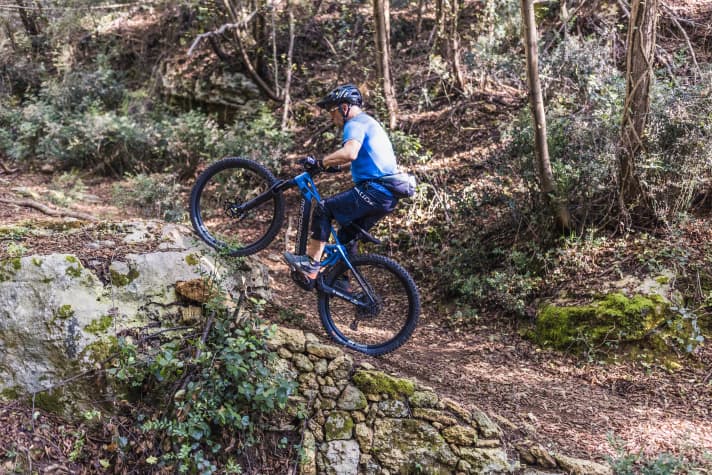 The impact against the step compresses the fork and rear triangle.