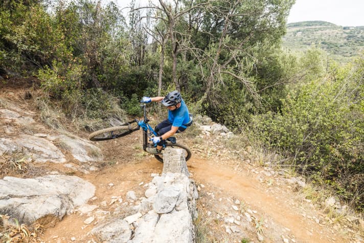 The rear wheel at the apex, the front wheel high in the air, and at full lean angle through the bend.