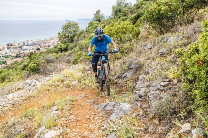 The bike turns back onto the trail on the rear wheel.