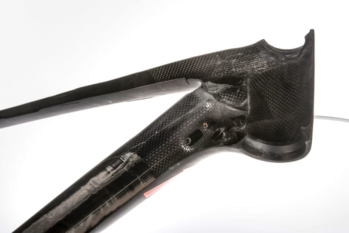 Exposed cables (B) inside the frame