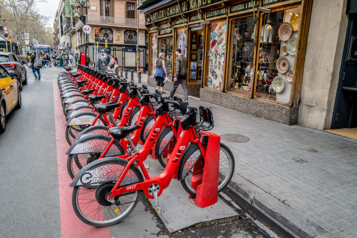 Bright red bicycle: The city's eye-catching hire bikes are not available to locals.