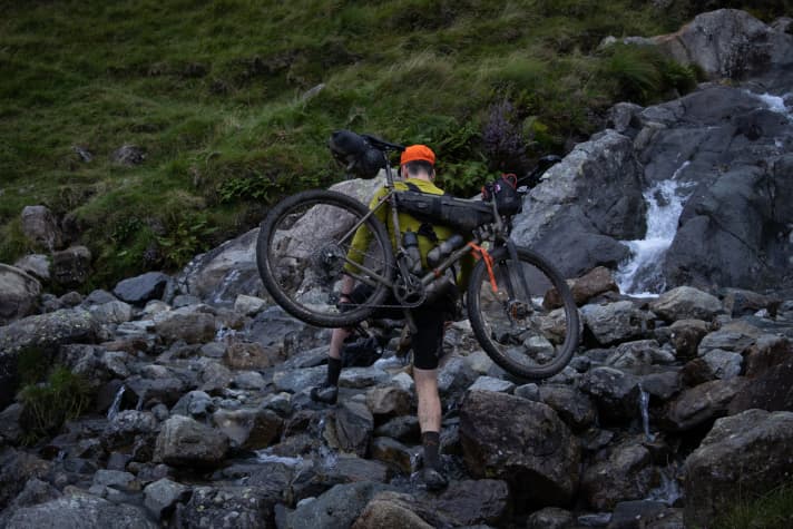 Carrying your bike like a rucksack - made possible by a carrying aid such as the Hike a Bike Harness from Restrap