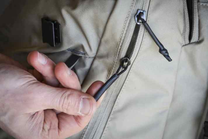 The zips are waterproof and run smoothly. With the small shrink tubes, they also sit comfortably in the hand.