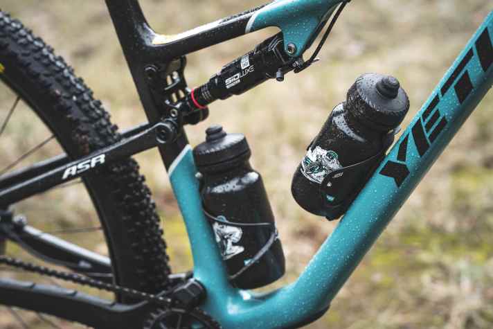 Two bottle cages are mandatory on a race bike. Yet fans reach for the matching water bottles.