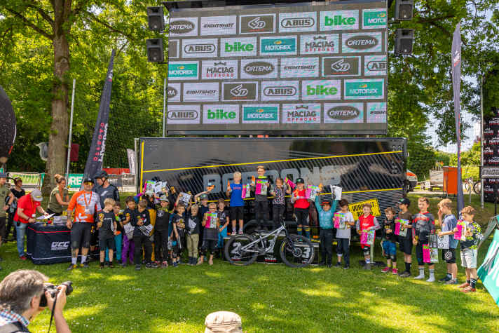 The young racers proudly show off their trophies.