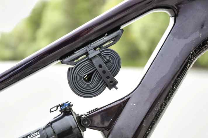 There is space under the top tube for a spare inner tube - there is no storage compartment.