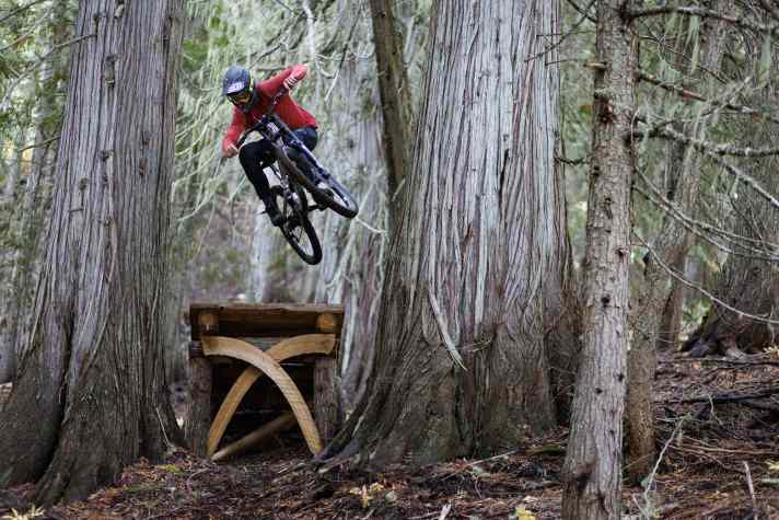 Russ Fountain dances over a wooden artwork and flies through the beautiful cedar trees in Nelson, B.C.