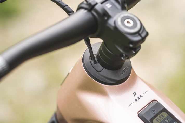 The cables run integrated through the headset into the frame.