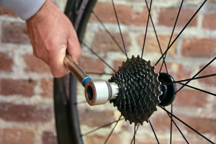 Nowadays, derailleur gears rely on so-called "cassettes": These, or their end ring, are released with a socket spanner.