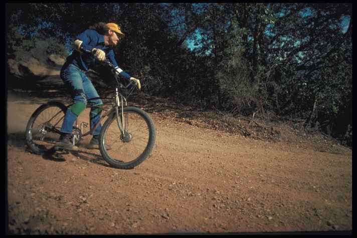 Charlie Kelly roars through the camera corner of the repack course in his modified Maroon/White Excelsior