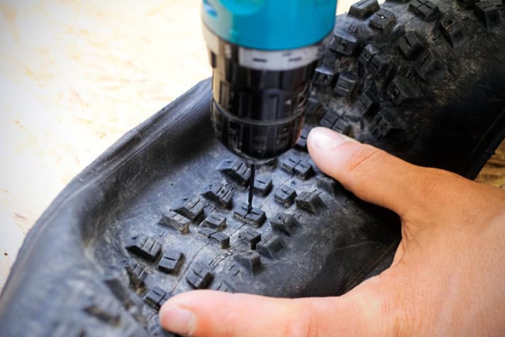 To ensure that the spikes are centred in the cleats, we drill the holes from the outside with a thin drill bit.