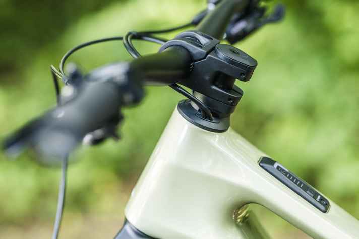 The cables run through the headset into the inside of the frame.