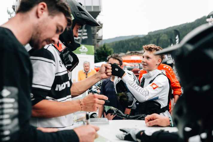 Fistbump with Lukas Knopf, while runner-up DH World Champion (2020) David Trummer swings the sharpie. | Miha Matavz