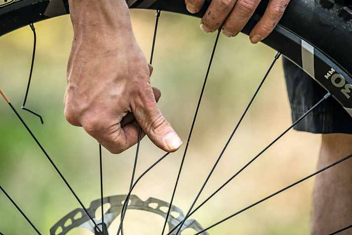 Broken spoke? Not a huge problem. However, the spoke should not fly around loose, but should at least be tied to other spokes in a makeshift manner.