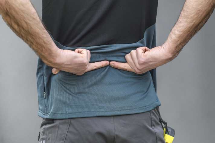 A second person can be helpful in finding the lower position or a belt placed at the correct height.