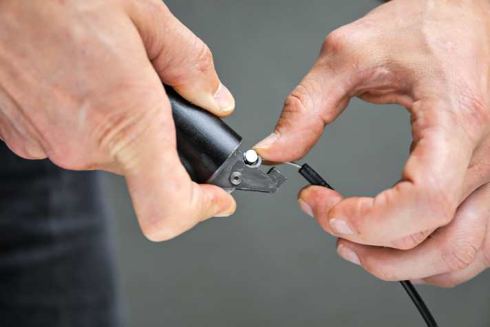 With most current supports, the end of the cable is simply hooked onto the lower end of the support