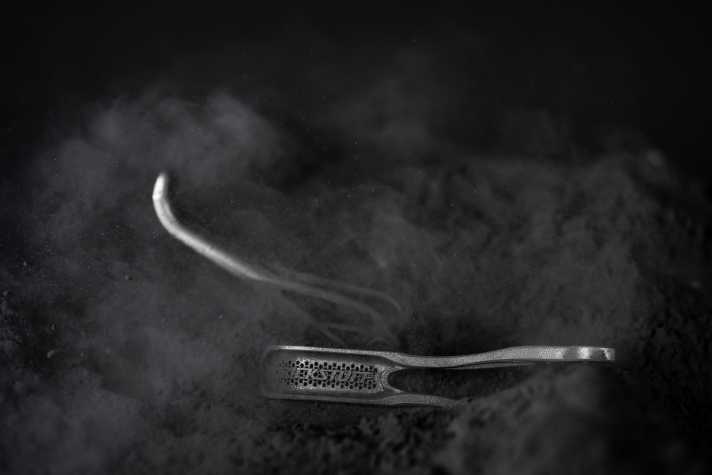 A laser melts the metal powder layer by layer.