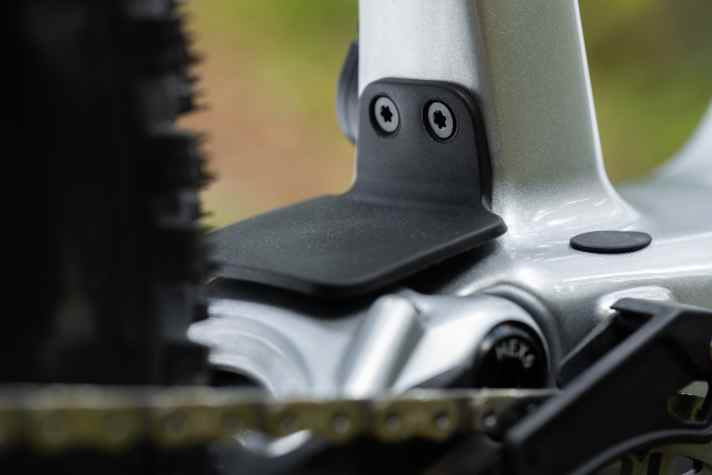 A rubber flap is designed to prevent pinching damage between the rear triangle and the main frame.