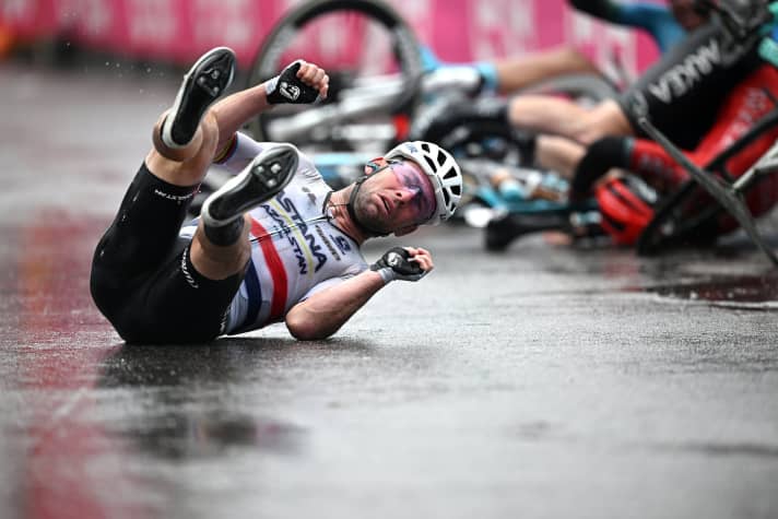 First slipped on a wet road marking during the sprint to the finish, then caught, only to take a major spill. Mark Cavendish crosses the finish line of stage 5 on the seat of his trousers.