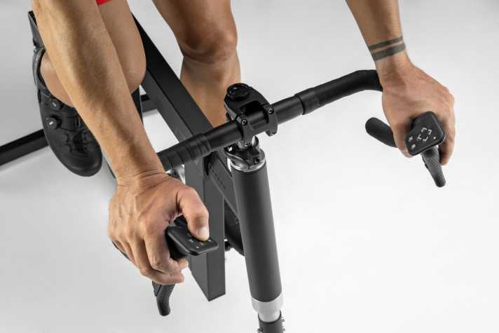 On the handlebars of the Elite Square Smart Frame: shift brake lever and game controller for control