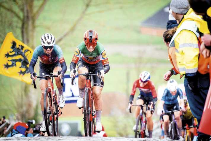 Leap to the front: Longo Borghini takes advantage of Kasia Niewiadoma's (left) attack to catch up with the leaders in the Tour of Flanders.