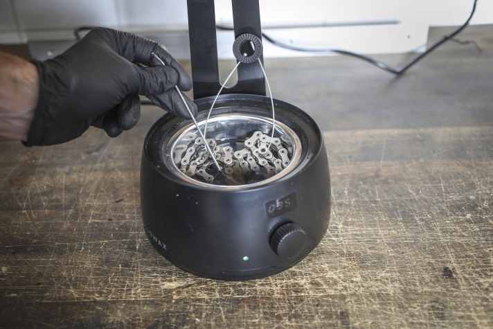 The chain will not burn, but you should still stir from time to time to distribute the wax better