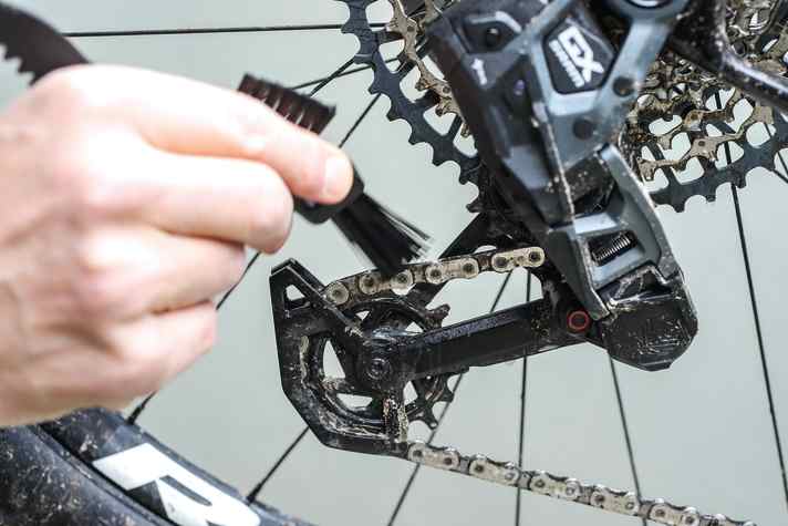 Small brush, hard bristles, big effect. Never use the frame brush for the drive!