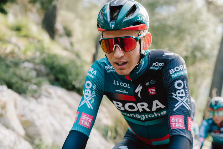 Lennard Kämna zeigt das neue Trikot von Bora-Hansgrohe