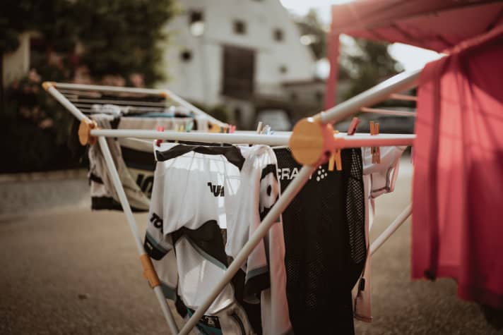 The first rays of sunshine reach the damp, clammy team outfits on Sunday morning.
