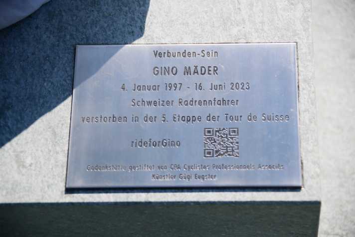 The memorial plaque at the base of the sculpture
