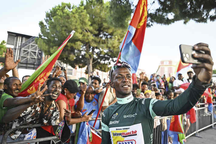 People's hero: Girmay is cheered by Eritrean compatriots at the finish line of the Tour de France