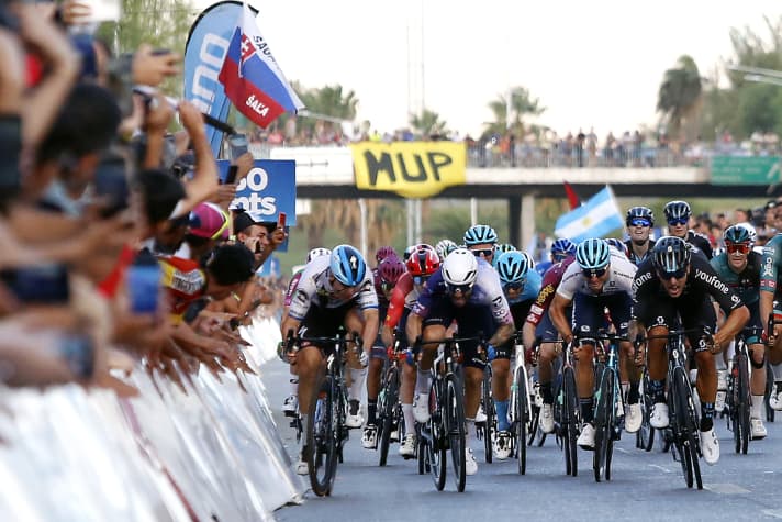 Jakobsen (left) gets a spectator's mobile phone during the finish sprint of stage 7 of the Vuelta a San Juan
