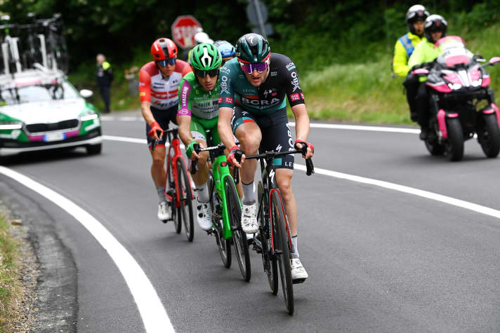 Nico Denz with Alessandro Tonelli and Toms Skujins on his rear wheel on the climb to Colle Braida. Hidden: Sebastian Berwick.