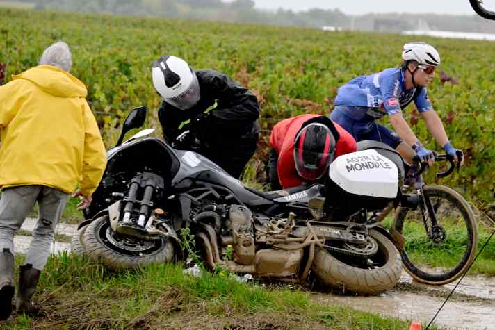 The wet gravel tracks also push the support bikes to their limits ... and beyond
