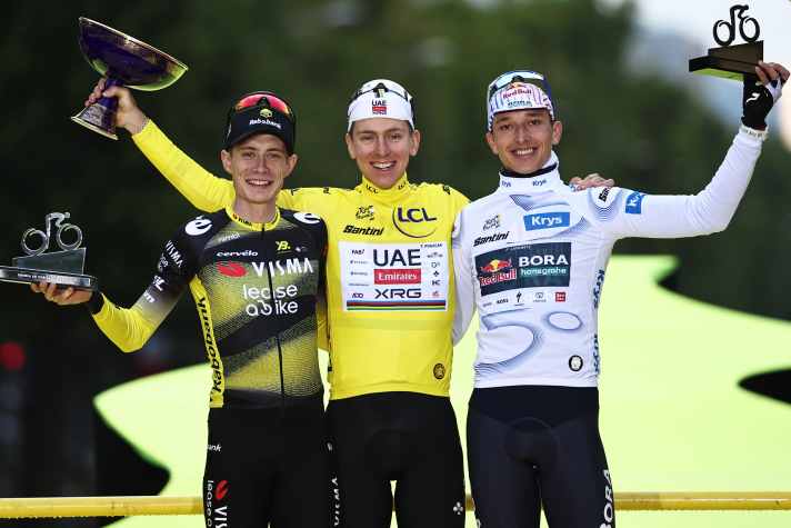 Beaming men: Lipowitz (right) is delighted to finish third in Paris alongside Tour winner Tadej Pogačar (centre) and runner-up Jonas Vingegaard (left)