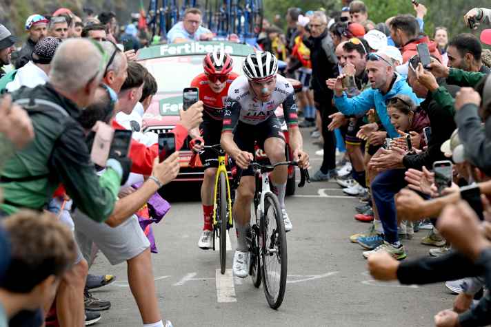 Duel: Joao Almeida (front) and Jonas Vingegaard on their way to Angliru.
