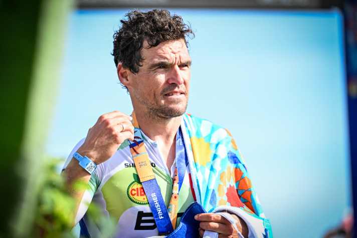 Successful finisher: Van Avermaet crosses the finish line as age group world champion