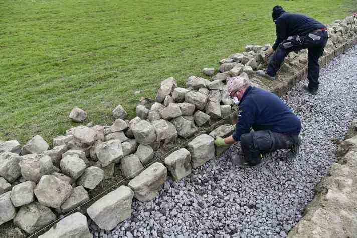 Les Amis de Paris Roubaix restoring a section of pavé