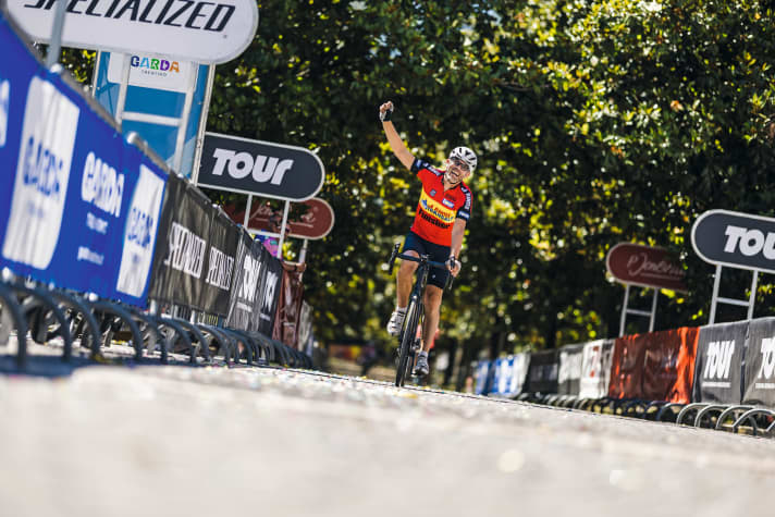Wearing the jersey of the first TOUR Transalp, Peter rolls to the finish in Arco