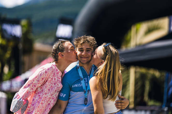 Finisher: Sister (left) and girlfriend greet Julian at the finish line. He proudly wears his finisher shirt