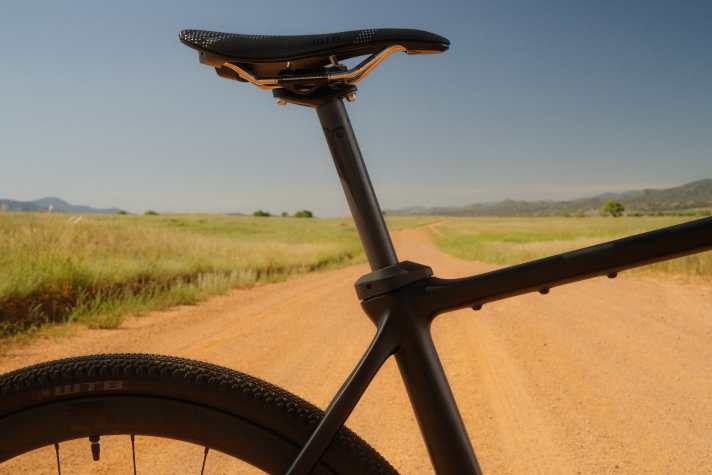 A rubber insert decouples the support from the frame and is intended to provide more flex