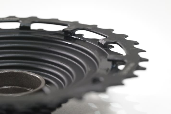 The steel-milled sprocket set of the E-Thirteen TRS+ 12-speed cassette with ratchet pinholes.