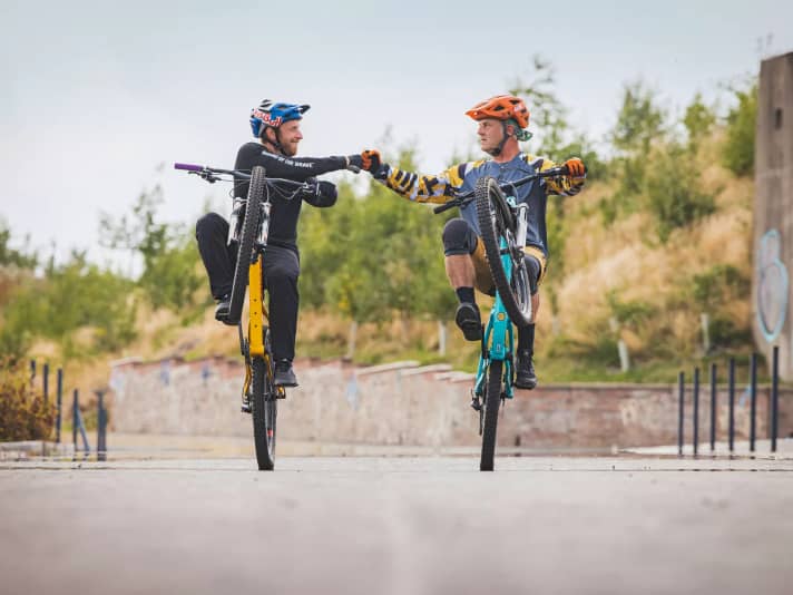Danny MacAskill with wheelie champion Hans Rey (right)
