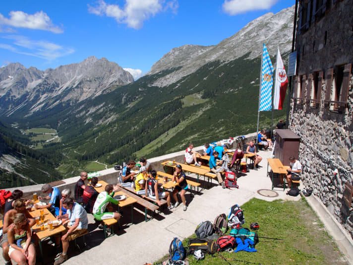   Bikers and mountaineers meet on the sun terrace of the Karwendelhaus.