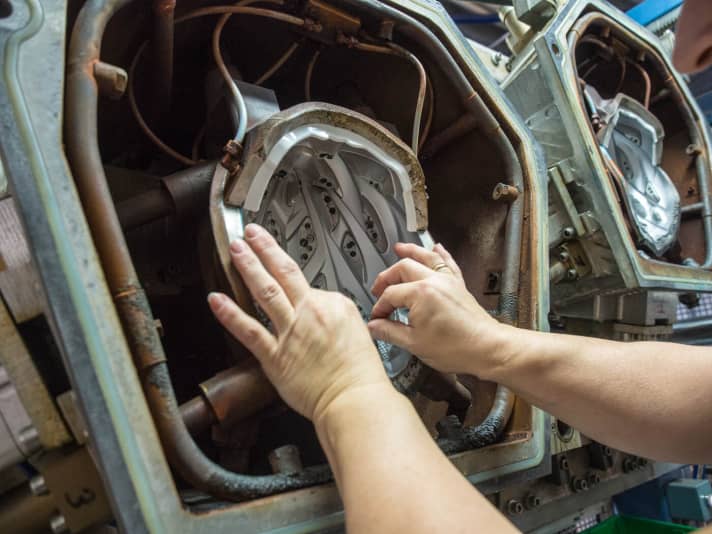   The individual parts are inserted into the injection moulds by hand.