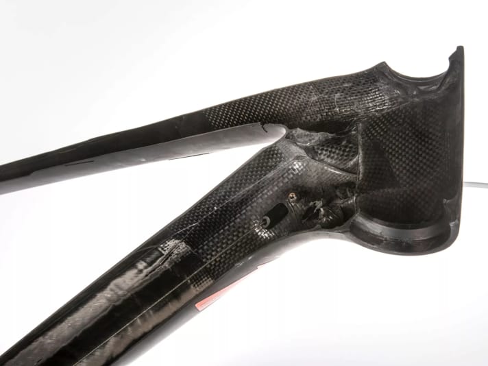 Exposed cables (B) inside the frame